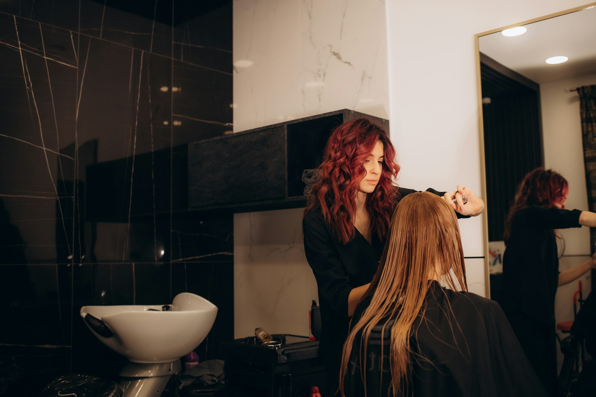 Young beautiful woman having her hair cut at the hairdresser's.